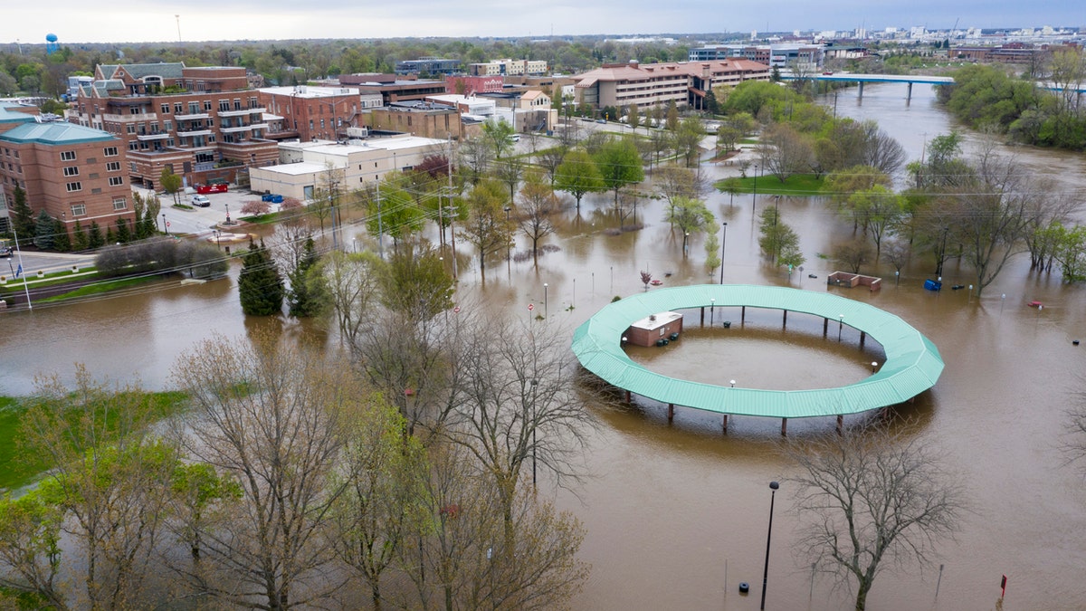 Water floods the Midland Area Farmers Market and the bridge along the Tittabawassee River in Midland, Mich., on May 19.