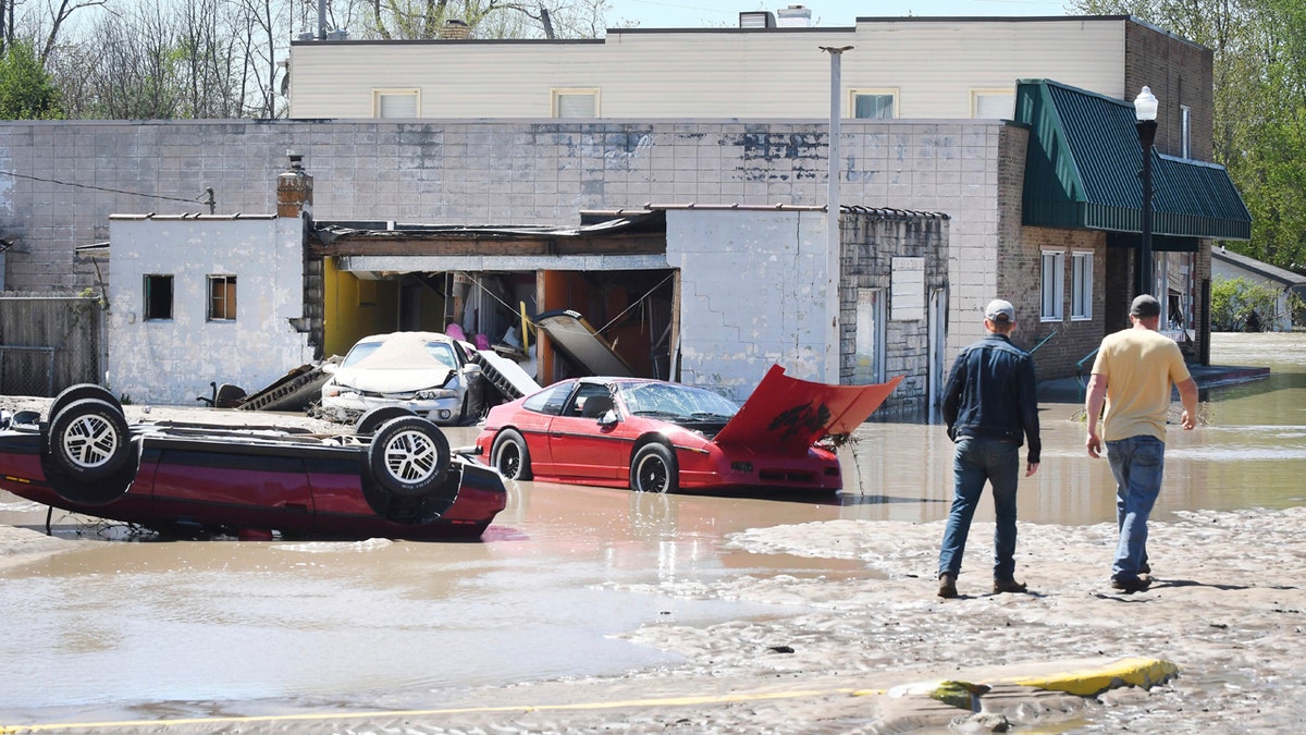 Cars are scattered and tipped over in downtown Sanford, Mich. after flooding along the Tittabawassee River on May 20.