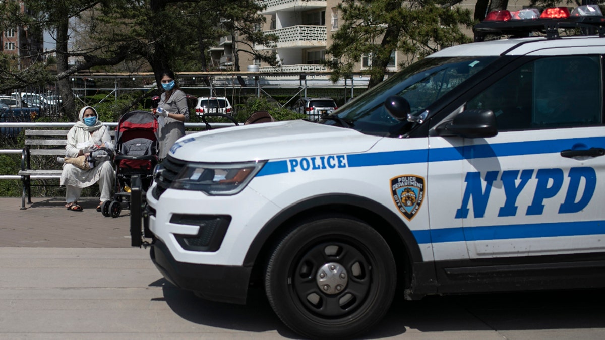 A New York City police car travels on the boardwalk along Brighton Beach with audio announcements blasting, reminding people to keep at least 6 feet apart in the Brooklyn borough of New York, on April 25. With the weather warming up, more people wearing personal protective equipment are seen venturing out to the parks and streets, though most still respecting the social distancing guidelines. (AP Photo/Wong Maye-E)
