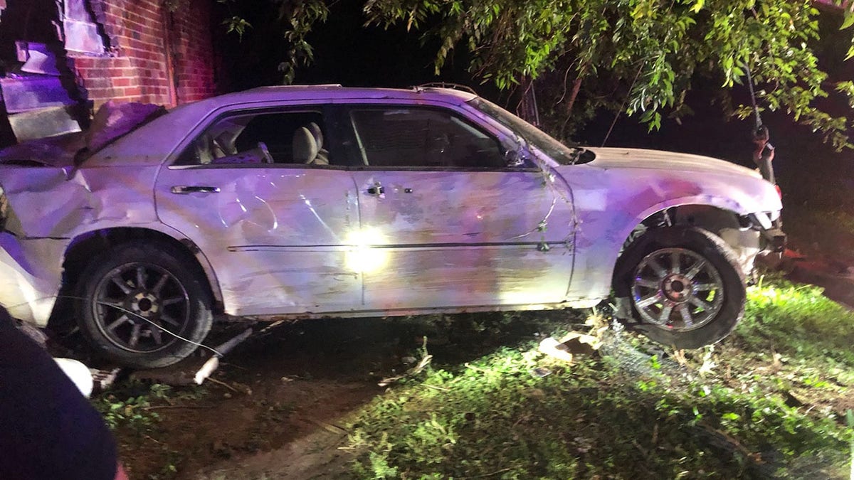 The driver crashed into a home and was arrested after police found him hiding on the roof of a house.