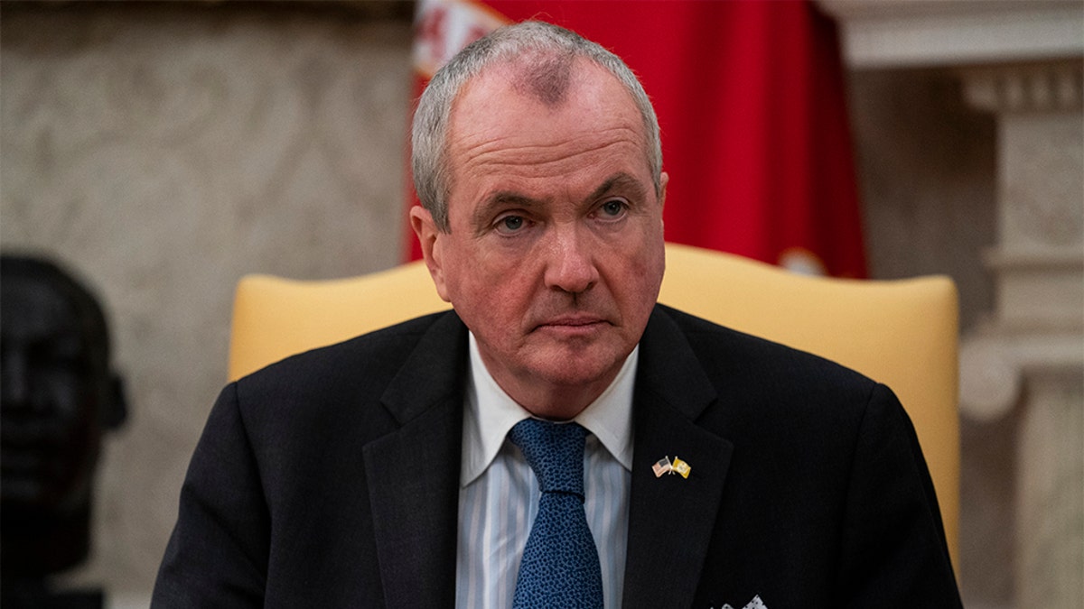 Gov. Phil Murphy, D-N.J., listens to President Donald Trump speak during a meeting about the coronavirus response in the Oval Office of the White House, Thursday, April 30, 2020, in Washington. (AP Photo/Evan Vucci)
