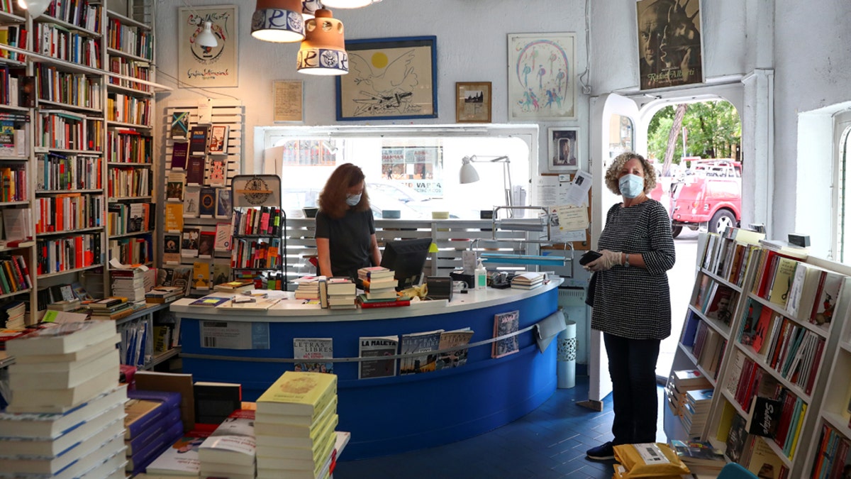 Lola Larumbe attends a customer inside her Rafael Alberti book shop amid the coronavirus disease (COVID-19) outbreak in Madrid, Spain, May 5, 2020.