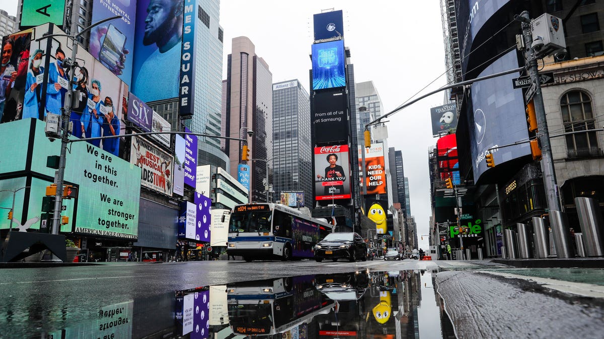 Vehicles move through a nearly empty Times Square during the coronavirus pandemic on May 23. (AP)