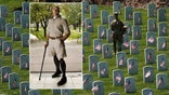 An Old Guard takes part in "Flags-In", an annual event where a small American flag is placed in front of more than 240,000 headstones of U.S. service members buried at Arlington National Cemetery in Arlington, Virginia, U.S., May 23, 2019. REUTERS/Kevin Lamarque - RC1714E9D160