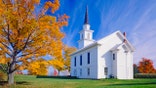 Autumn sugar maple and country church in Vermont