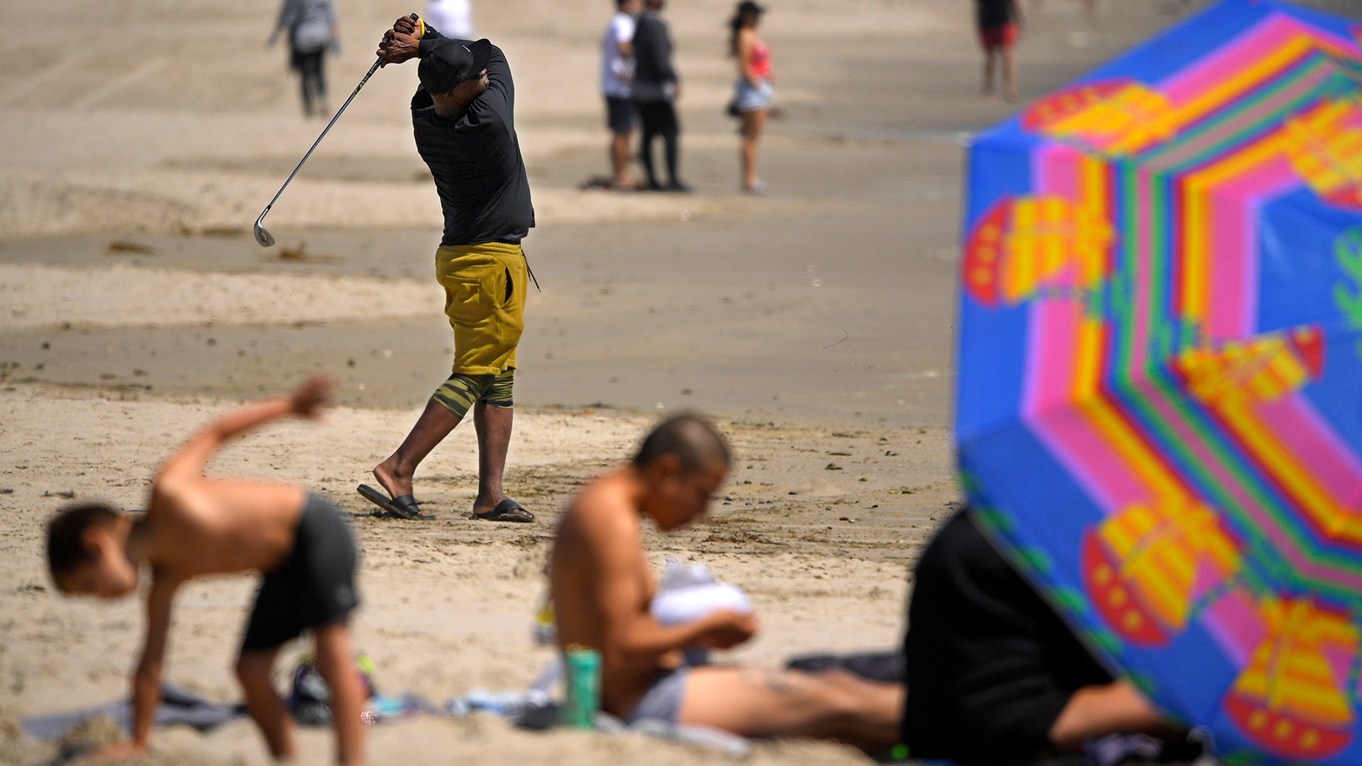 Sarge Hall practices his golf swing at Venice Beach during the coronavirus outbreak in Los Angeles, May 13, 2020. 