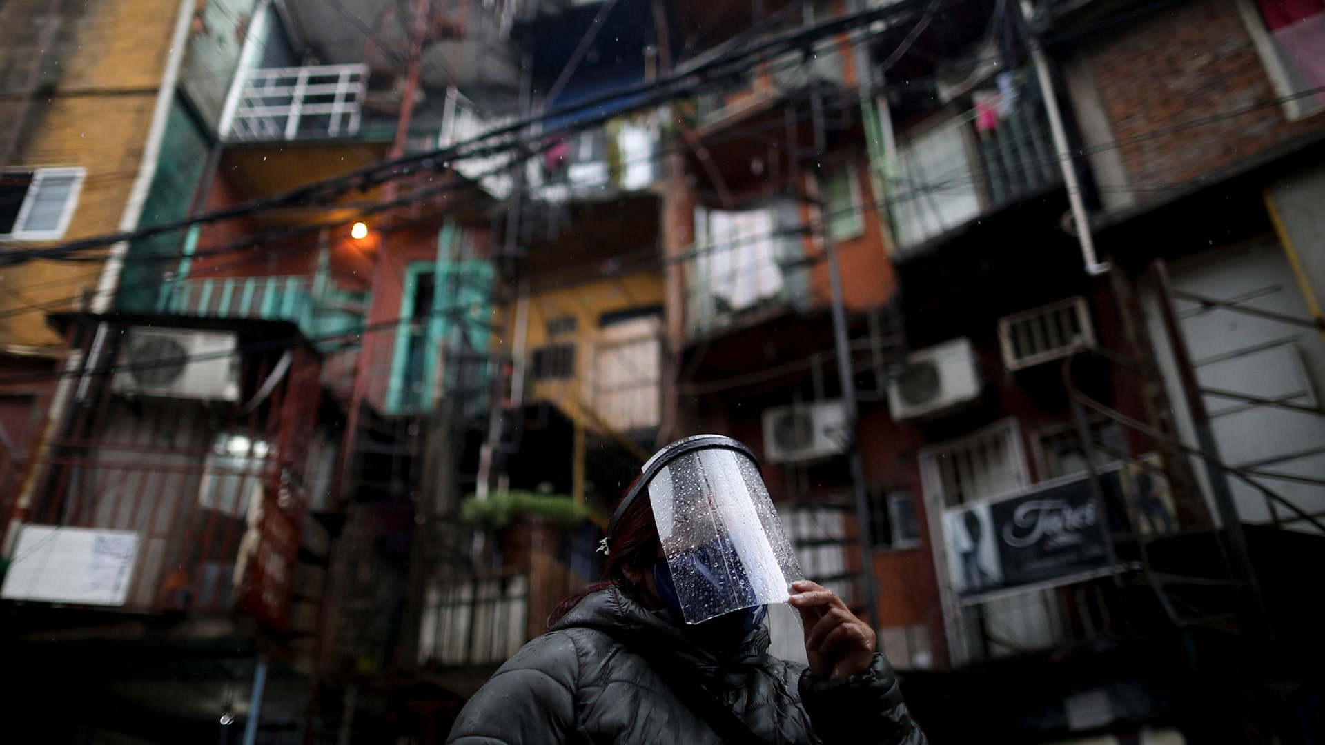 A woman walks wearing a face shield at the Villa 31 neighborhood during a government-ordered lockdown to curb the spread of the coronavirus in Buenos Aires, Argentina, May 4, 2020. 
