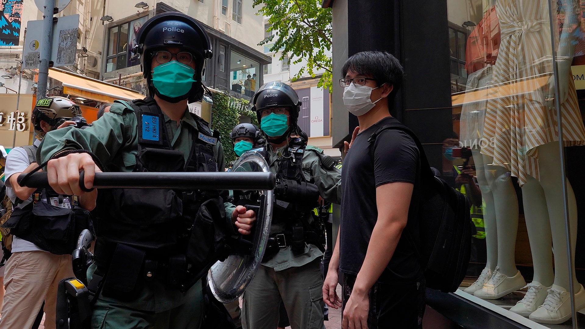 Riot police form a line as they check pedestrians gathered in the Central district of Hong Kong, May 27, 2020. 