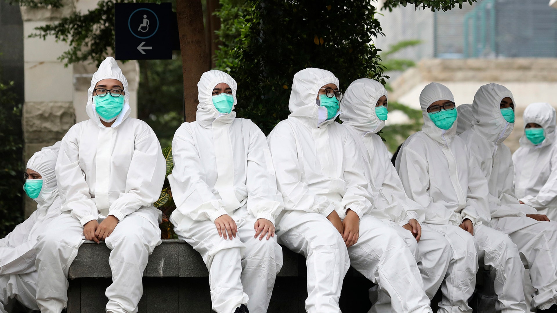 Medical workers take a break at a coronavirus mobile test site in Jakarta, Indonesia, May 6, 2020. 