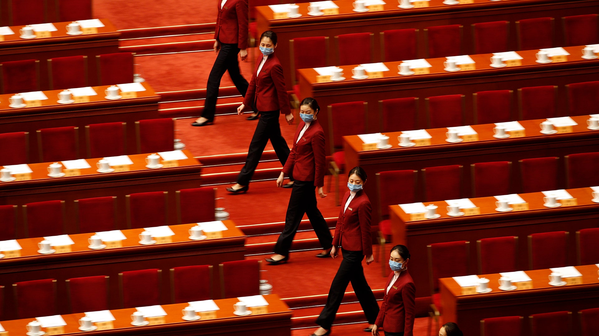Tea hostesses prepare for the closing session of the Chinese People's Political Consultative Conference at the Great Hall of the People in Beijing, May 27, 2020. 