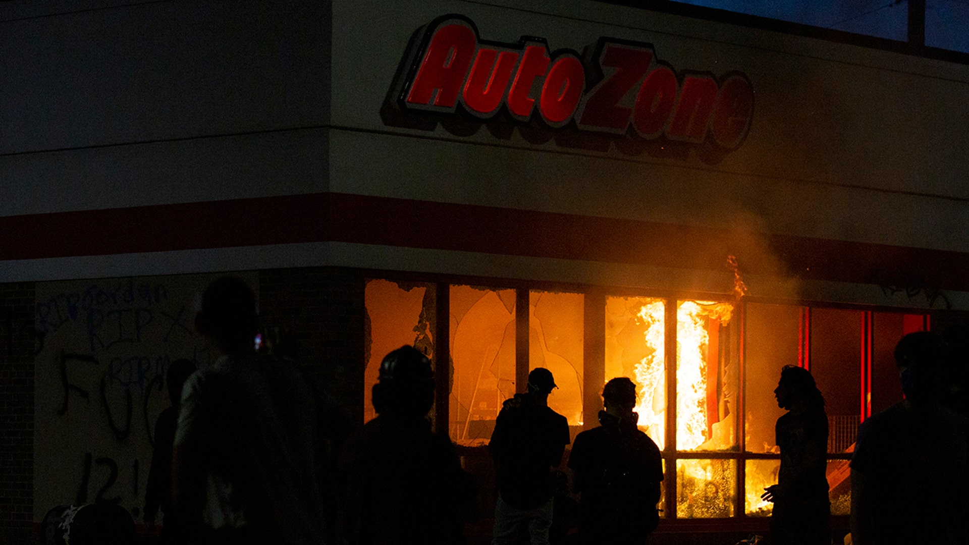 A fire burns in an AutoZone store during a protest Wednesday, May 27, 2020, in Minneapolis against the death of George Floyd in Minneapolis police custody earlier in the week.