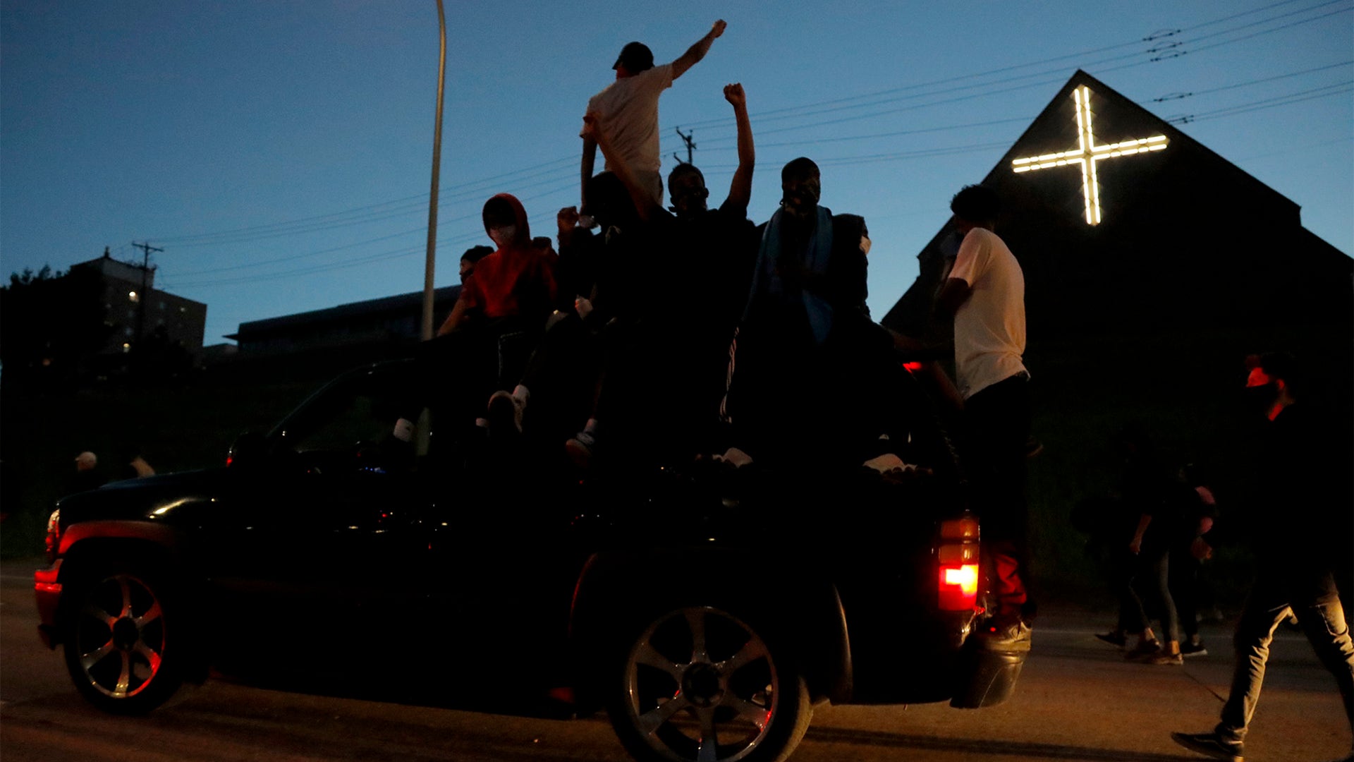 Protests ride down a street in Minneapolis.