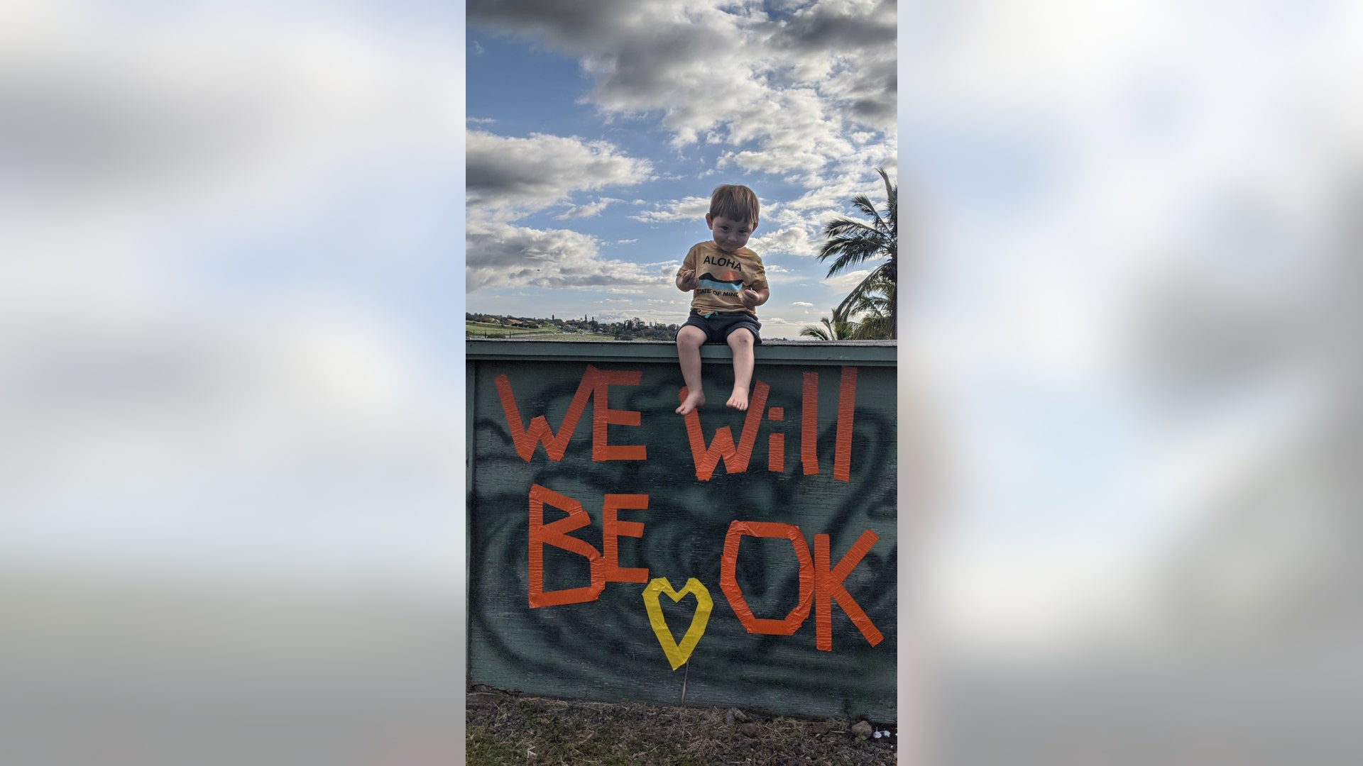 This is William, almost two. We live in Maui Hawaii and have been on lockdown for over 5 weeks. We live in a neighborhood that we still walk daily. One day we came across this power box at the edge of the neighborhood. Someone had used tape to write "we will be OK". Our children are a symbol of hope as they are still optimistic and content each day we stay home. Will is a constant reminder that through it all, we "Will" be OK.