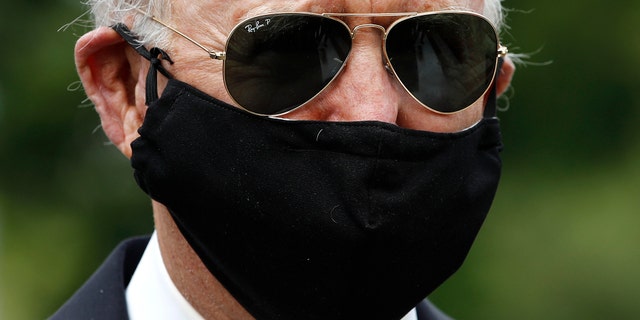 Democratic presidential candidate, former Vice President Joe Biden wears a face mask to protect against the spread of the new coronavirus as he and Jill Biden depart after placing a wreath at the Delaware Memorial Bridge Veterans Memorial Park, Monday, May 25, 2020, in New Castle, Del. Biden could mathematically secure the Democratic presidential nomination Tuesday in the middle of a pandemic. (AP Photo/Patrick Semansky)
