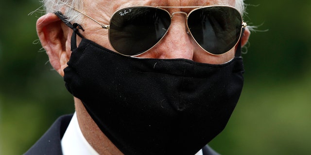 Democratic presidential candidate, former Vice President Joe Biden wears a face mask to protect against the spread of the new coronavirus as he and Jill Biden depart after placing a wreath at the Delaware Memorial Bridge Veterans Memorial Park, Monday, May 25, 2020, in New Castle, Del. Biden could mathematically secure the Democratic presidential nomination Tuesday in the  middle of a pandemic. (AP Photo/Patrick Semansky)