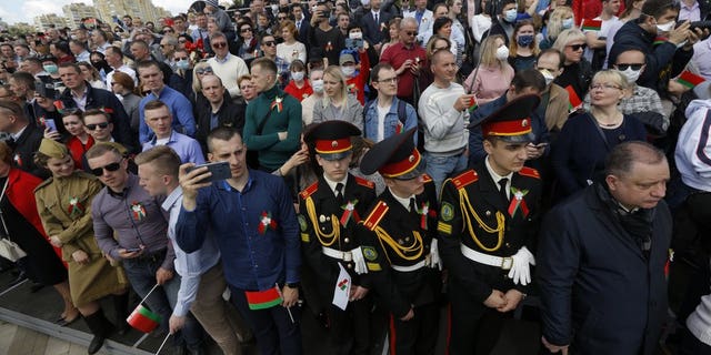 People attend the Victory Day military parade that marked the 75th anniversary of the allied victory over Nazi Germany, in Minsk, Belarus, Saturday, May 9, 2020. Belarus remains one of the few countries that hadn't imposed a lockdown or restricted public events despite recommendations of the World Health Organization.
