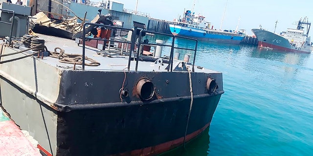 In this photo provided Monday, May 11, 2020, by the Iranian Army, the Konarak support vessel which was struck during a training exercise in the Gulf of Oman, is docked in an unidentified naval base in Iran. An Iranian missile fired during a training exercise in the Gulf of Oman struck a support vessel near its target, killing 19 sailors and wounding 15, Iran's state media reported on Monday, amid heightened tensions between Tehran and the U.S. (Iranian Army via AP)
