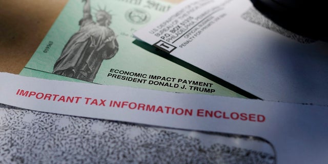 President Trump's name is seen on a stimulus check issued by the IRS to help combat the adverse economic effects of the COVID-19 outbreak, in San Antonio. (AP Photo/Eric Gay)