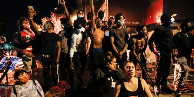 Trump blasts Minneapolis mayor, vows military support if needed 3 Protestors demonstrate outside of a burning Minneapolis 3rd Police Precinct, Thursday, May 28, 2020, in Minneapolis. Protests over the death of George Floyd, a black man who died in police custody Monday, broke out in Minneapolis for a third straight night. (AP Photo/John Minchillo)