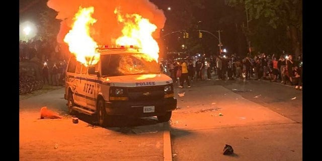 A police van goes up in flames in New York City. 