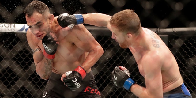Justin Gaethje, right, punches Tony Ferguson during a UFC 249 mixed martial arts bout, Saturday, May 9, 2020, in Jacksonville, Fla. (AP Photo/John Raoux)