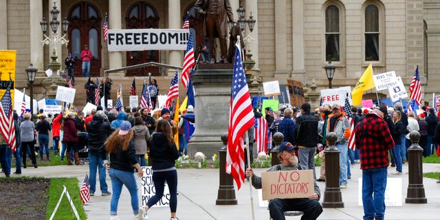Protesters rally at the State Capitol in Lansing, Mich.