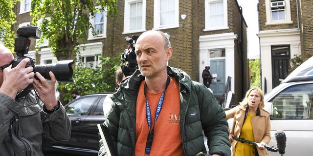 Dominic Cummings, center, leaving his London home Sunday morning. (AP Photo/Alberto Pezzali)