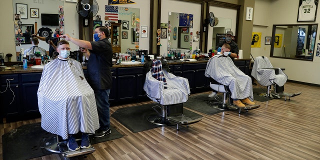 Barbershops in Indiana have been closed to prevent the spread of the coronavirus since March 25, and were allowed to open Monday by appointment and following social distancing guidelines. (AP Photo/Michael Conroy)