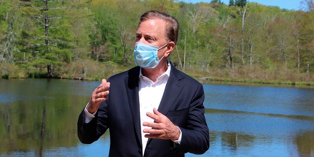 Connecticut Gov. Ned Lamont speaks to reporters at Gay City State Park in Hebron, Connecticut.