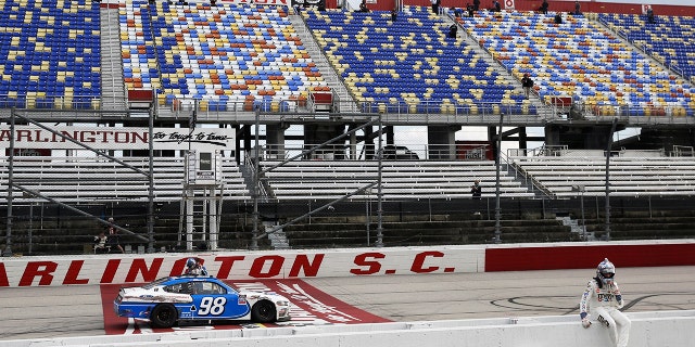 Kyle Busch sits on the pit wall after finishing second to Chase Briscoe (98) in the NASCAR Xfinity series auto race Thursday, May 21, 2020, in Darlington, S.C. (AP Photo/Brynn Anderson)
