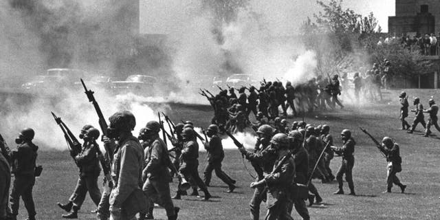 In this May 4, 1970 file photo, Ohio National Guard soldiers move in on war protestors at Kent State University in Kent, Ohio. Four persons were killed and multiple people were wounded when National Guardsmen opened fire. (AP Photo, File)