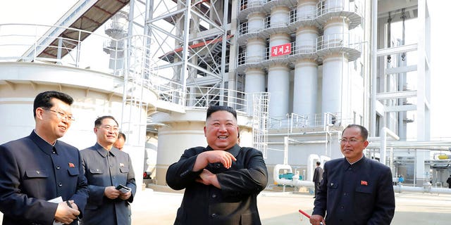 In this Friday, May 1, 2020, photo provided by the North Korean government, North Korean leader Kim Jong Un, center, visits a fertilizer factory in Sunchon, South Pyongan province, near Pyongyang, North Korea. 