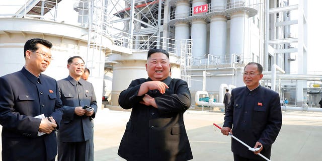 In this Friday, May 1, 2020, photo provided by the North Korean government, North Korean leader Kim Jong Un, center, visits a fertilizer factory in Sunchon, South Pyongan province, near Pyongyang, North Korea. 