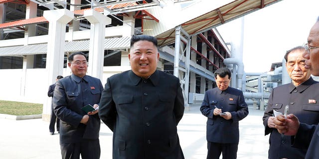 In this Friday, May 1, 2020, photo provided by the North Korean government, North Korean leader Kim Jong Un, center, visits a fertilizer factory in Sunchon, South Pyongan province, near Pyongyang, North Korea. 