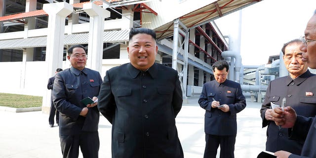 In this Friday, May 1, 2020, photo provided by the North Korean government, North Korean leader Kim Jong Un, center, visits a fertilizer factory in Sunchon, South Pyongan province, near Pyongyang, North Korea. 