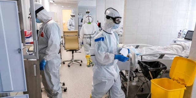 Doctors work inside the intensive care unit for people infected with the new coronavirus, at a hospital in Moscow, Russia. 