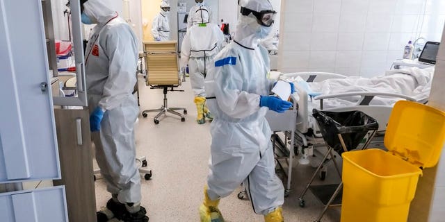 Doctors work inside the intensive care unit for people infected with the new coronavirus, at a hospital in Moscow, Russia.