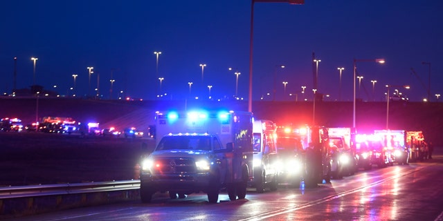 The procession of emergency vehicles for retired paramedic Paul Cary makes its way out of Denver International Airport on Sunday, May 3, 2020m, in Denver. Cary died from coronavirus after volunteering to help combat the pandemic in New York City. (Helen H. Richardson/The Denver Post via AP, Pool)