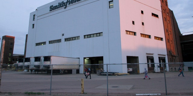 Employees of two departments at the Smithfield pork processing plant in Sioux Falls, S.D. report to work on Monday, May 4, 2020, as the plant moved to reopen after a coronavirus outbreak infected workers. (AP Photo/Stephen Groves)