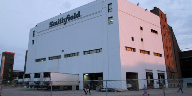 Employees of two departments at the Smithfield pork processing plant in Sioux Falls, S.D. report to work on Monday, May 4, 2020, as the plant moved to reopen after a coronavirus outbreak infected workers. (AP Photo/Stephen Groves)