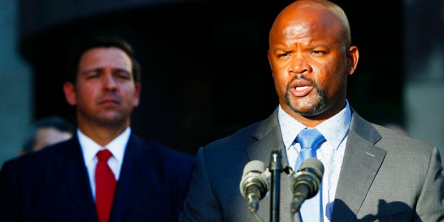 FILE: Acting Broward County sheriff Gregory Tony, right, speaks after being introduced by Florida Gov.