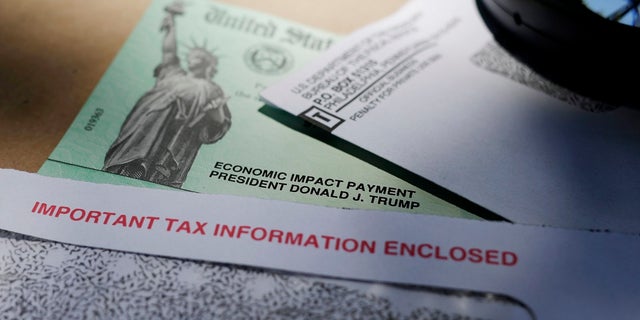 A New York woman pleaded guilty to COVID-19 relief fraud after police found multiple stolen identification cards in her car. (AP Photo/Eric Gay)