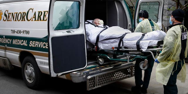A patient is loaded into an ambulance by emergency medical workers outside Cobble Hill Health Center in Brooklyn, New York, on April 17, 2020. (AP Photo/John Minchillo, File)