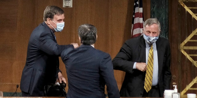 Senate Intelligence Committee Chairman Richard Burr, right, and Vice Chairman Mark Warner, left, greeting Rep. John Ratcliffe at his hearing Tuesday.