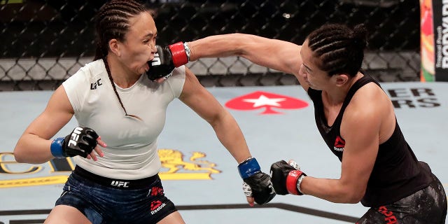 Carla Esparza, right, lands a punch on Michelle Waterson during a UFC 249 mixed martial arts bout, Saturday, May 9, 2020, in Jacksonville, Fla. (Associated Press)