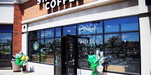The Southtown Starbucks Coffee business, which was closed in March and reopened late last week, has a "WELCOME BACK" to customers on the windows Monday in Bloomington, Minn, where customers can pick up their online orders at curbside. (AP Photo/Jim Mone)
