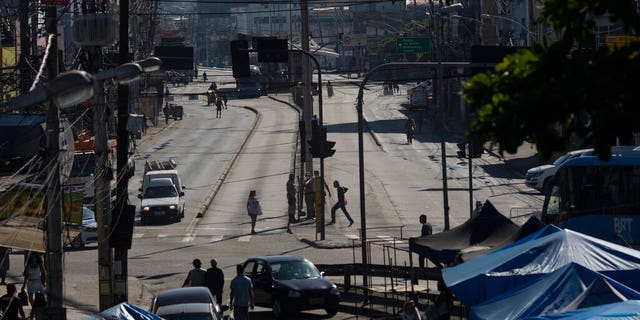 An avenue is partially empty amid increased restrictions on movements in an effort to curb the spread of the new coronavirus in the Madureira neighborhood of Rio de Janeiro, Brazil.