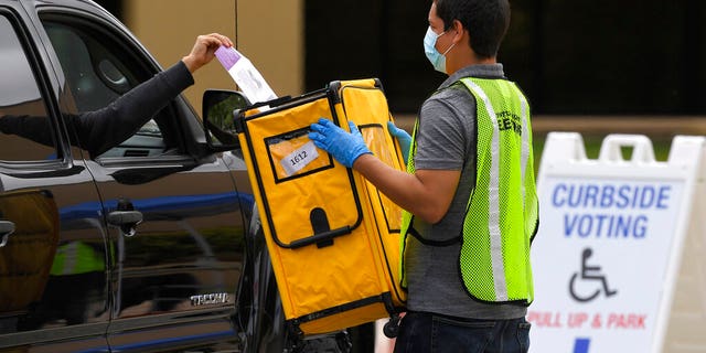 Voters drop off ballots in a special election for California's 25th Congressional District during the coronavirus outbreak, Tuesday, May 12, 2020, in Simi Valley, Calif. Republican Mike Garcia and Democrat Christy Smith are running for the seat after the resignation of Rep. Katie Hill, D-Calif. (AP Photo/Mark J. Terrill)