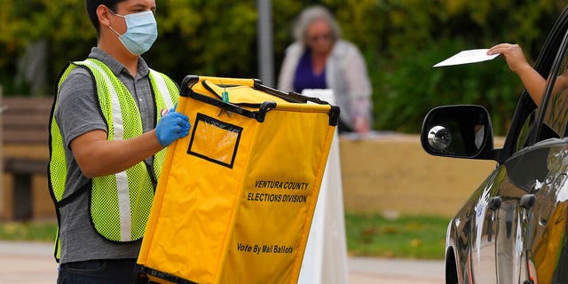 Voters drop off ballots in a special election for California's 25th Congressional District during the coronavirus outbreak, Tuesday, May 12, 2020, in Simi Valley, Calif. Republican Mike Garcia and Democrat Christy Smith are running for the seat after the resignation of Rep. Katie Hill, D-Calif. (AP Photo/Mark J. Terrill)