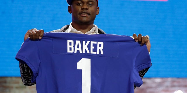 Georgia defensive back DeAndre Baker poses with his new jersey after the New York Giants selected him in the first round at the NFL football draft in Nashville, Tenn last April. Miramar police issued arrest warrants for both men last Thursday. (AP Photo/Mark Humphrey, File)